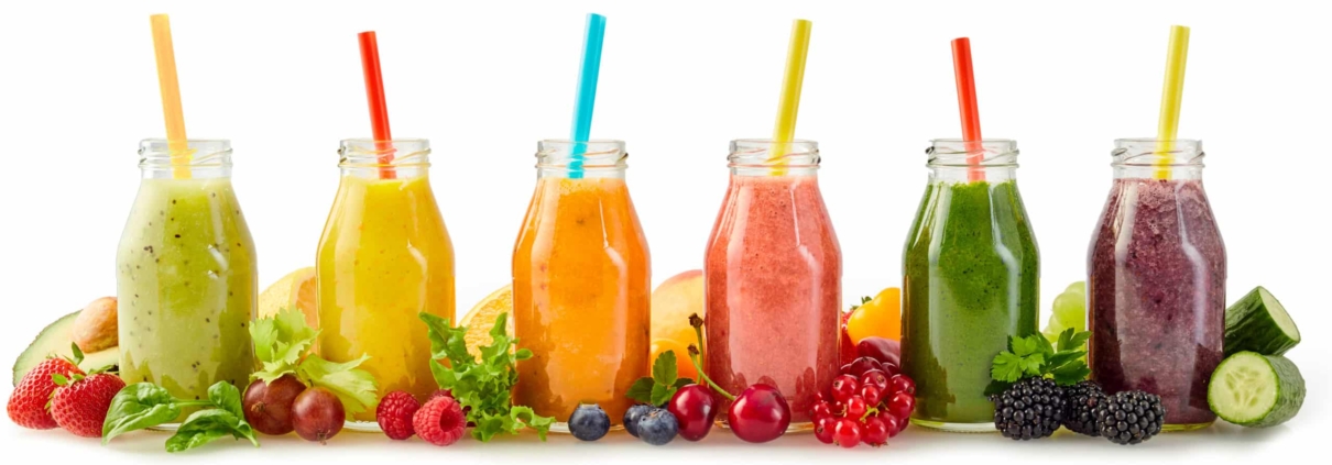 A row of healthy fresh fruit smoothies for hair nutritional needs