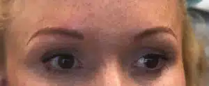A close up of a woman's eyebrows enhanced with Eyebrow Microblading.