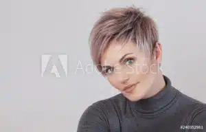 Portrait of a young woman with short hair and hair loss.