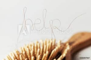 A hair brush with the word help written on it, designed specifically for addressing hair loss and thinning.