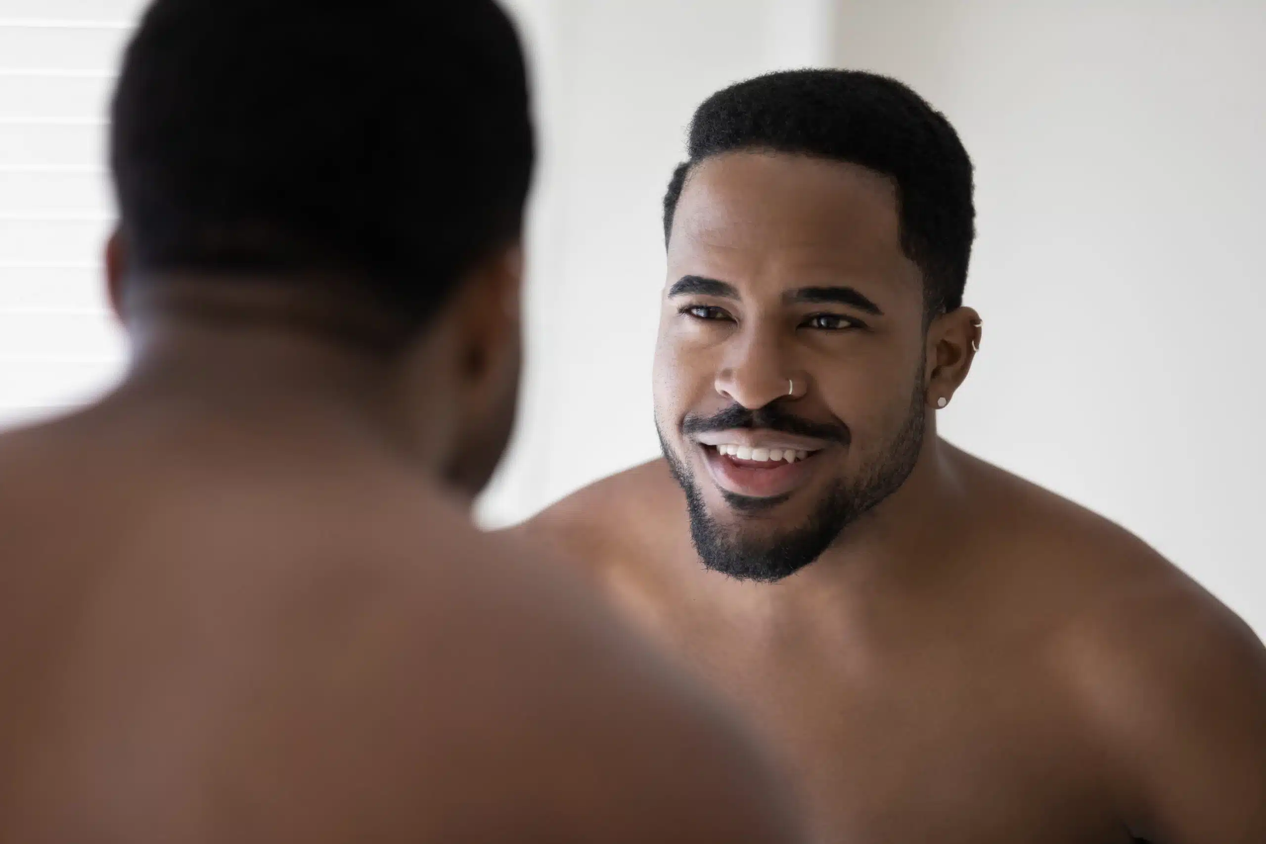 Man Looking At Himself In The Mirror