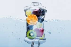 A bag filled with fruit floating in water, potentially used for IV therapy.