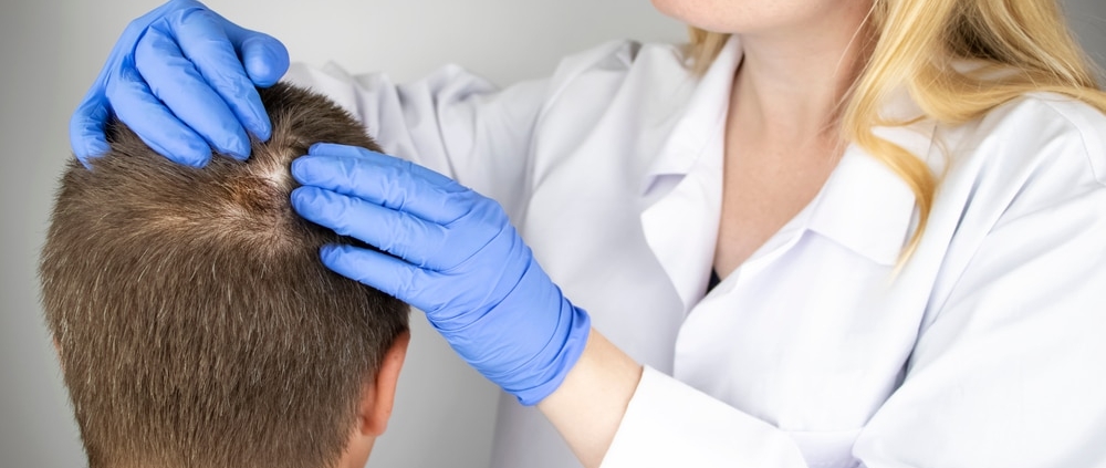 Doctor examining patient's hair