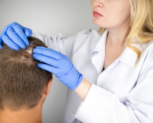 Doctor examining patient's hair