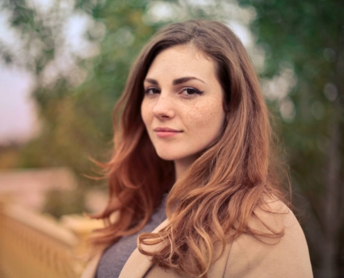 Portrait of a woman wearing a brown coat