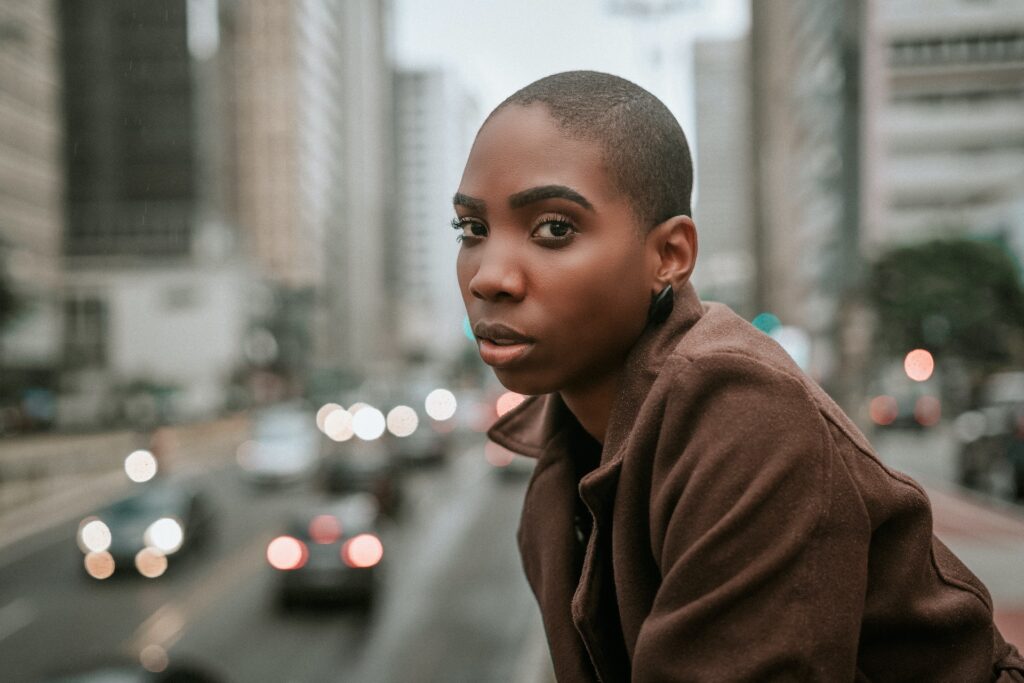 A woman looking at the camera with very short pixie-cut hair