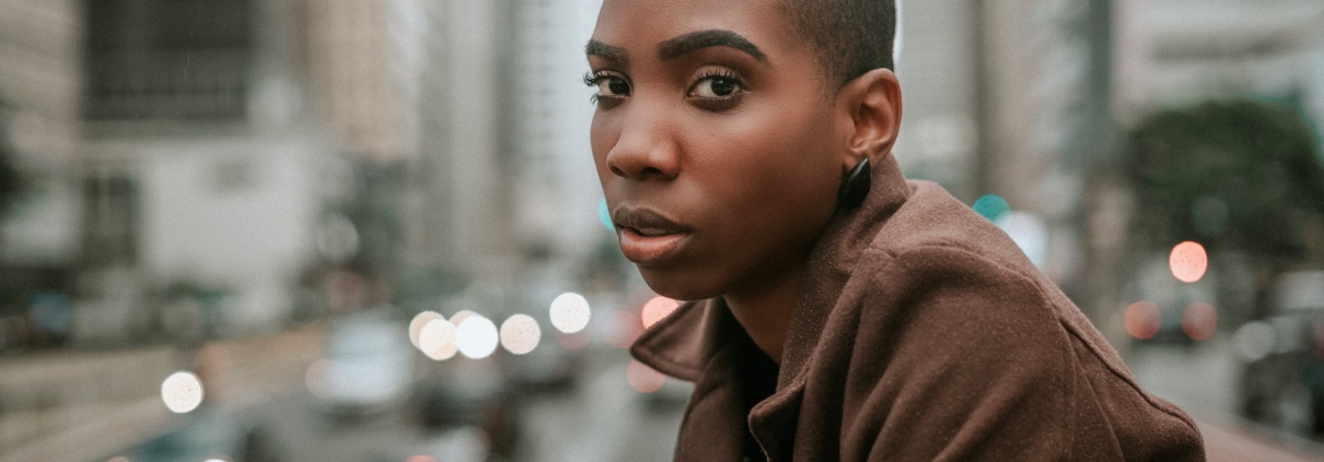 A woman looking at the camera with very short pixie-cut hair